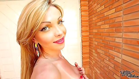 Blonde on the beach enjoys the dirt on her big natural tits